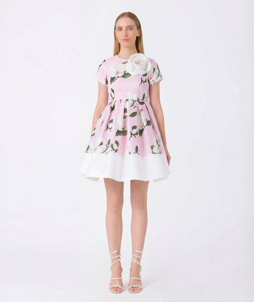 Woman wearing a pink floral dress on a white background
