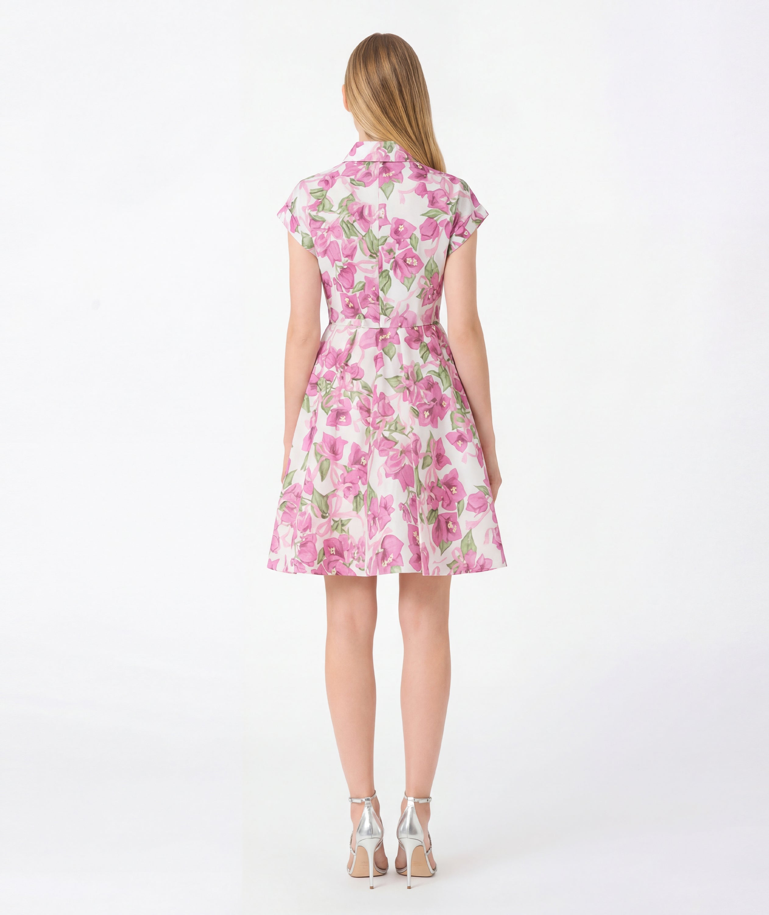 Woman wearing a pink floral dress on a white background