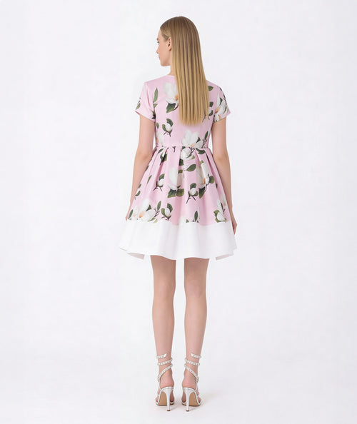 Woman wearing a pink floral dress on a white background