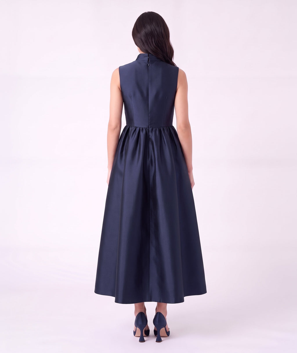 Back view of the Crystal Collar Navy Women’s Dress from Mama Luma’s Suva Maia Collection, featuring a full satin skirt and concealed back zipper.