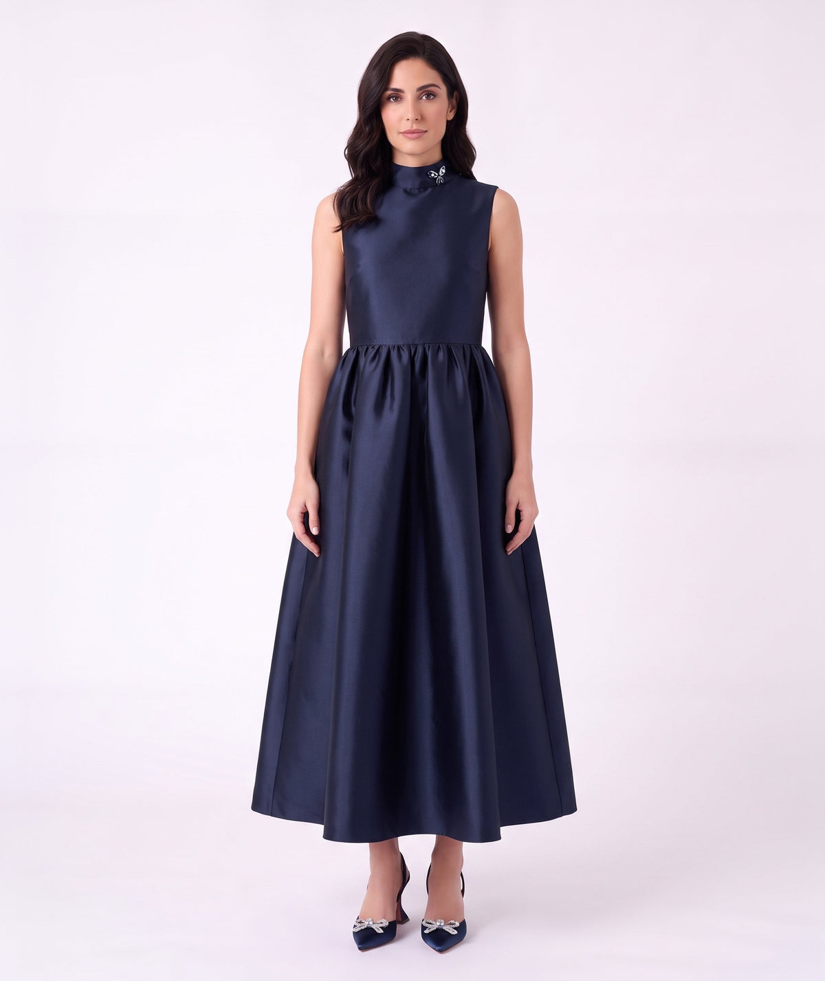 Front view of the Crystal Collar Navy Women’s Dress from Mama Luma’s Suva Maia Collection, featuring a crystal-accented high neckline and full satin skirt.