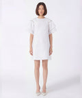 Woman wearing a white dress on a white background