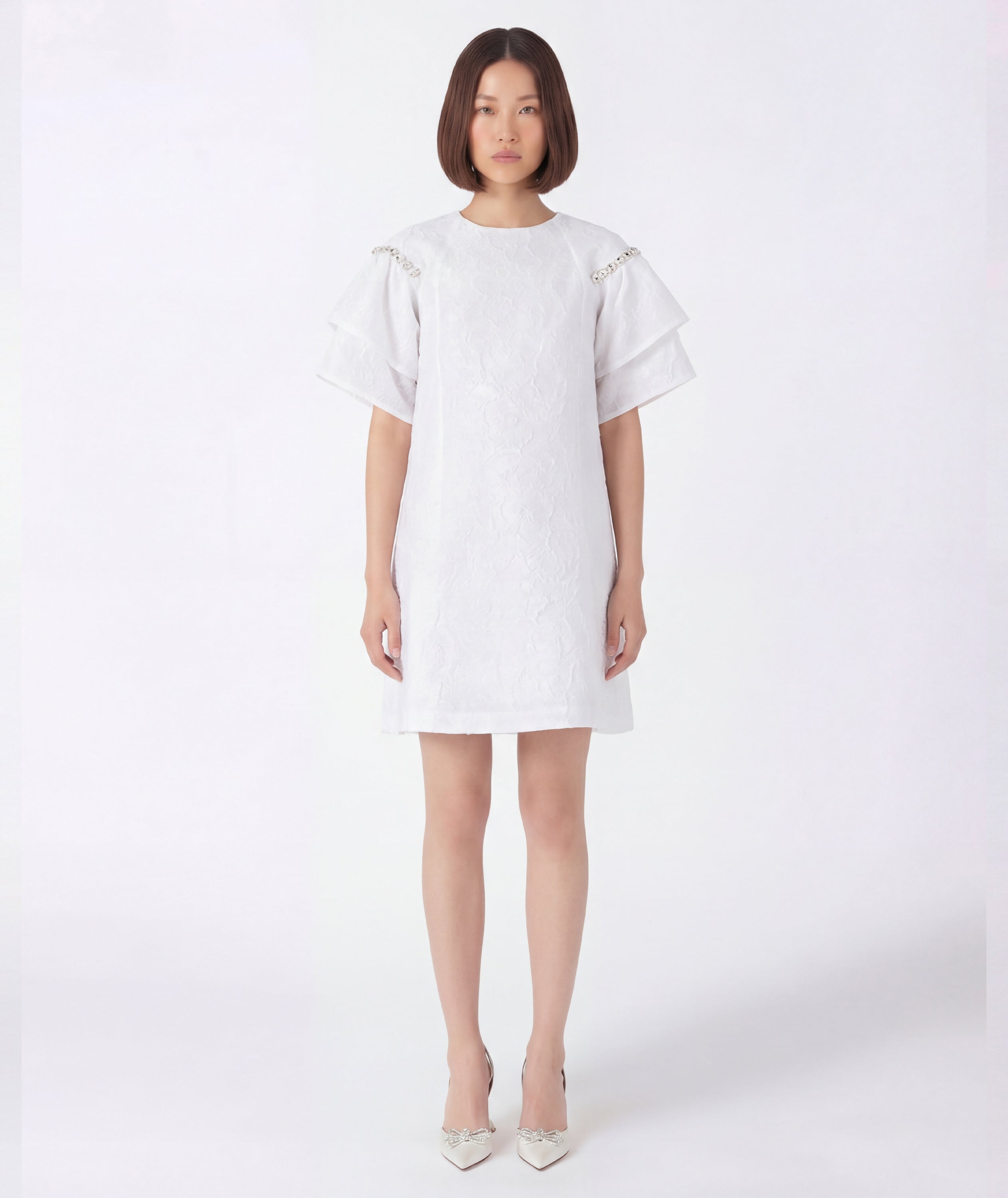 Woman wearing a white dress on a white background