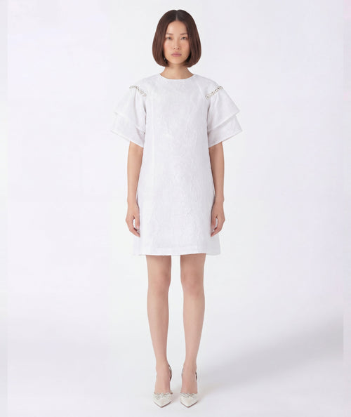 Woman wearing a white dress on a white background
