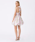 Woman wearing a floral dress with a white background