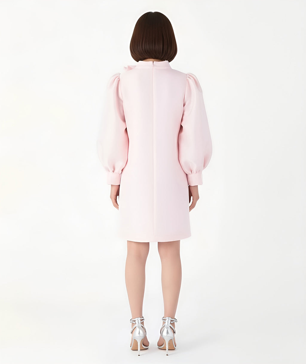 Back view of Mama Luma’s pastel pink women’s dress featuring voluminous puff sleeves and a minimal A-line silhouette, designed for elegant Mommy & Me coordination. Perfect for Christmas gatherings, family photos, and festive dinners. Available in sizes XS–XL.