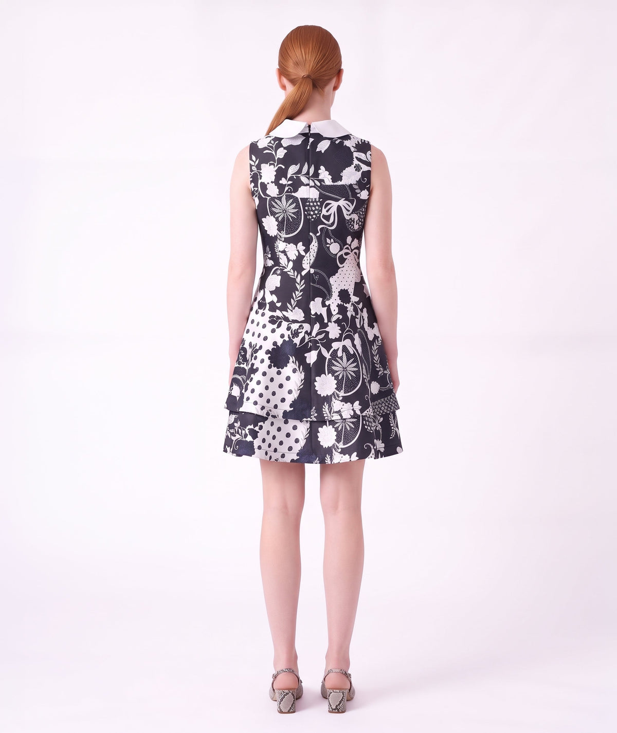 Back view of the Suva Maia Collared Women’s Dress featuring a navy and ivory botanical print, contrast collar, and structured silhouette by Mama Luma.