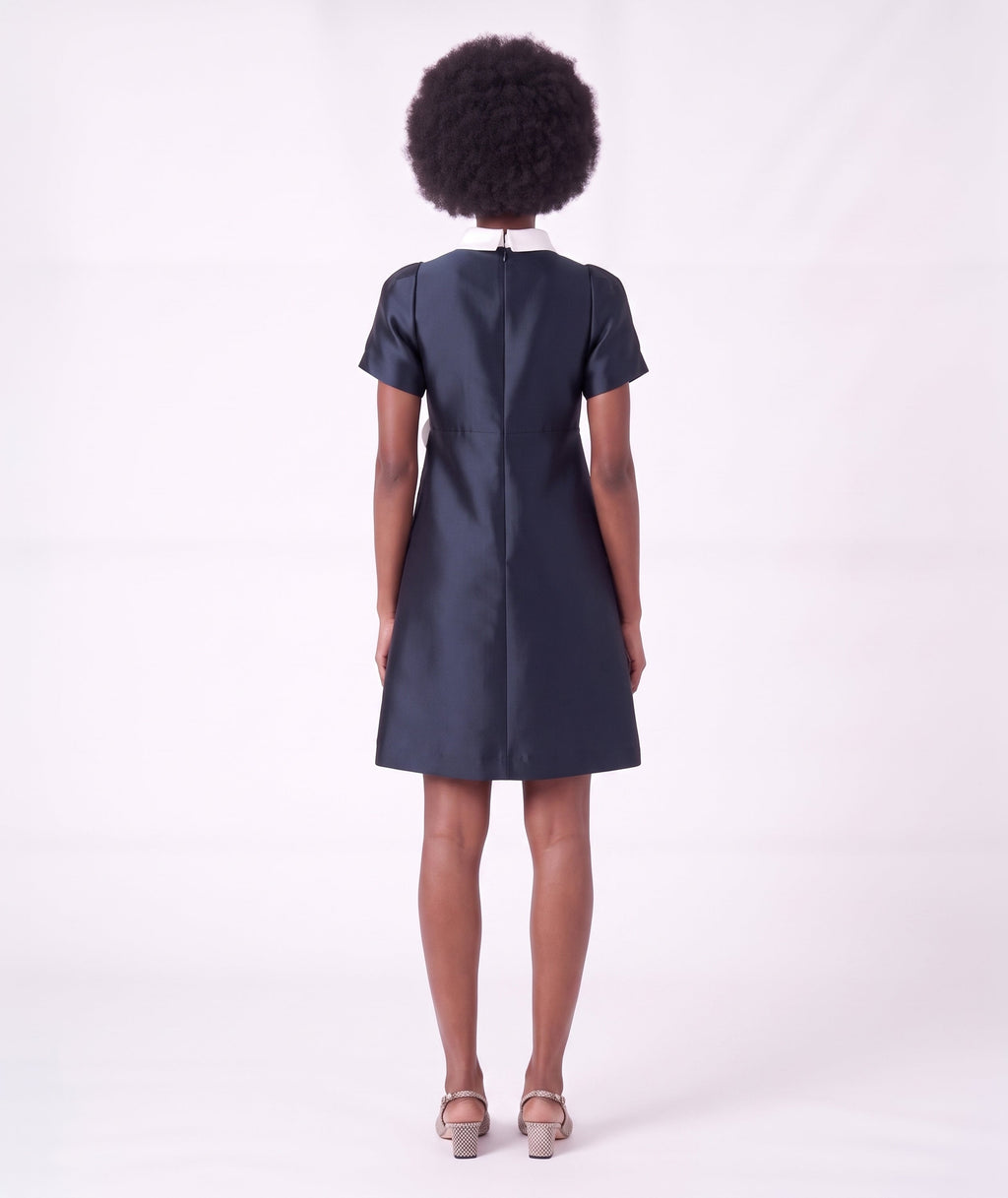 Back view of the Suva Maia Flower Women’s Dress in navy with an ivory high collar and tailored A-line silhouette by Mama Luma.